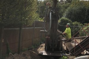 Op deze afbeelding is te zien hoe een werknemer van Albreco een grondboring maakt voor een aardwarmtesysteem.